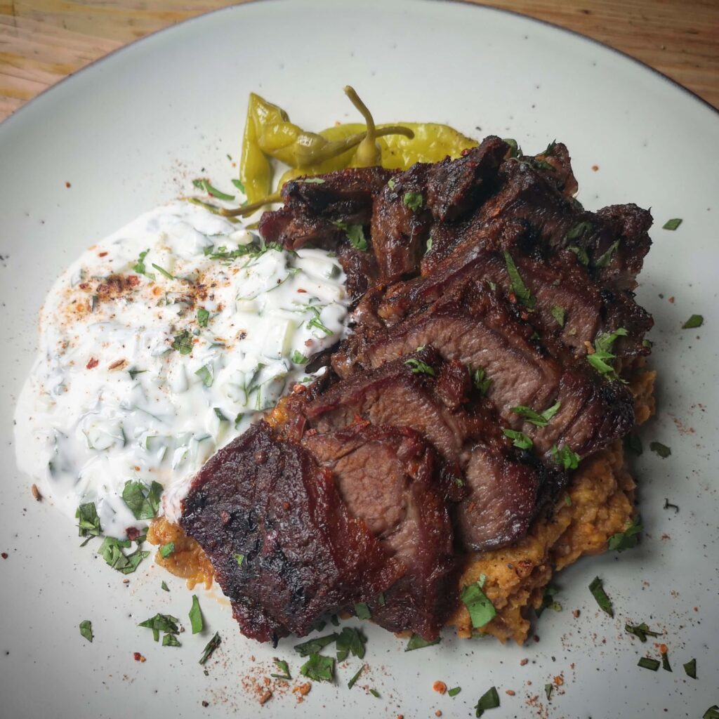 Smokey and spicy short rib, with sweet potato dhal, raita and pickles